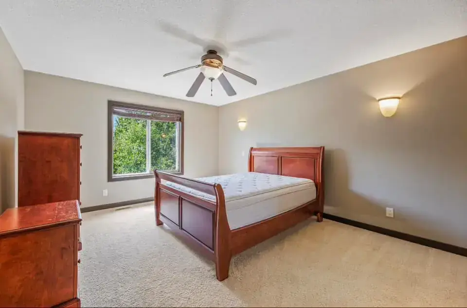 Finished basement with family room, modern lighting, and luxury vinyl flooring
