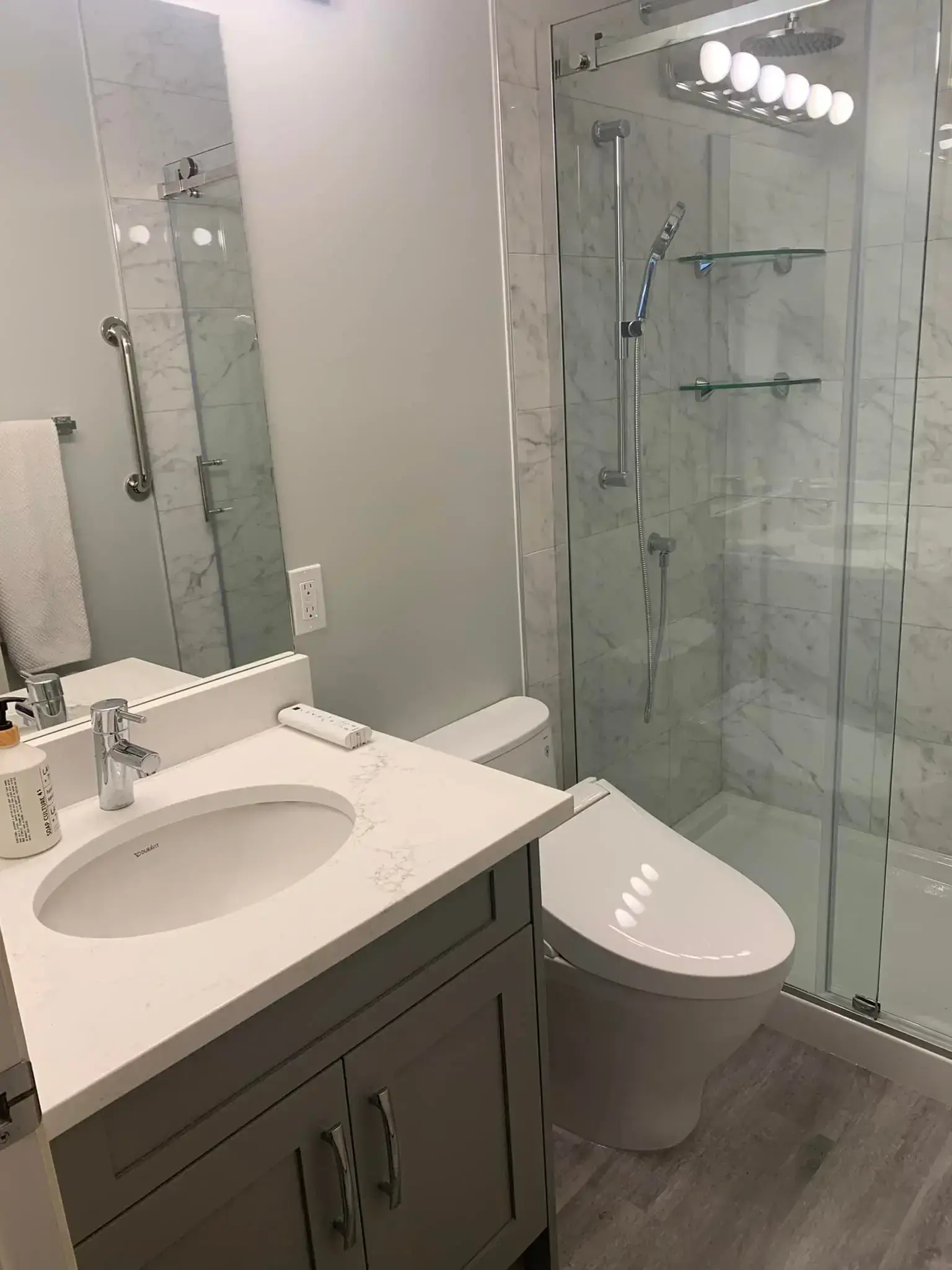 Spa-inspired bathroom with walk-in shower, glass enclosure, and natural stone tile