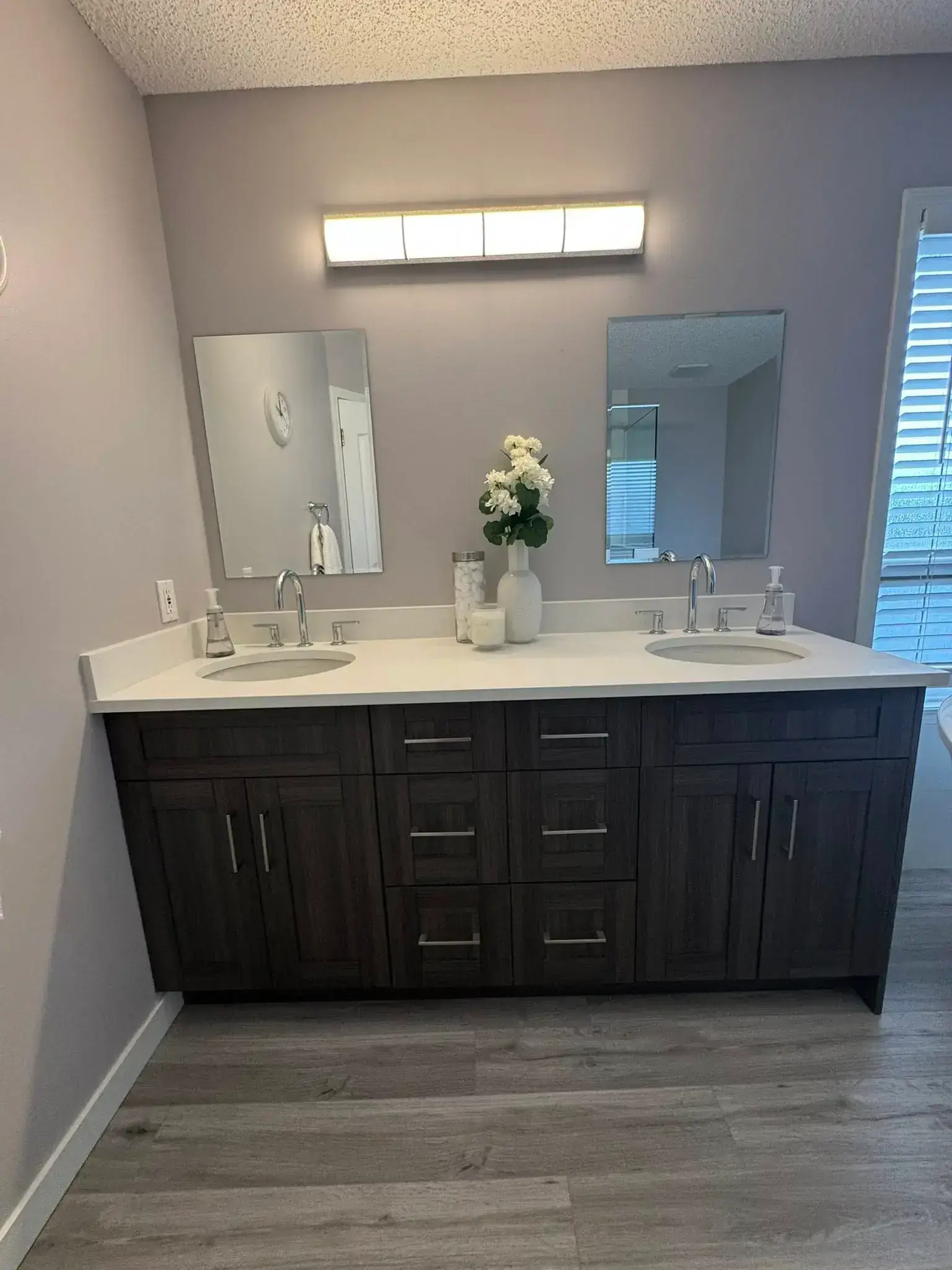 Luxurious bathroom with soaking tub, marble tile, and elegant fixtures