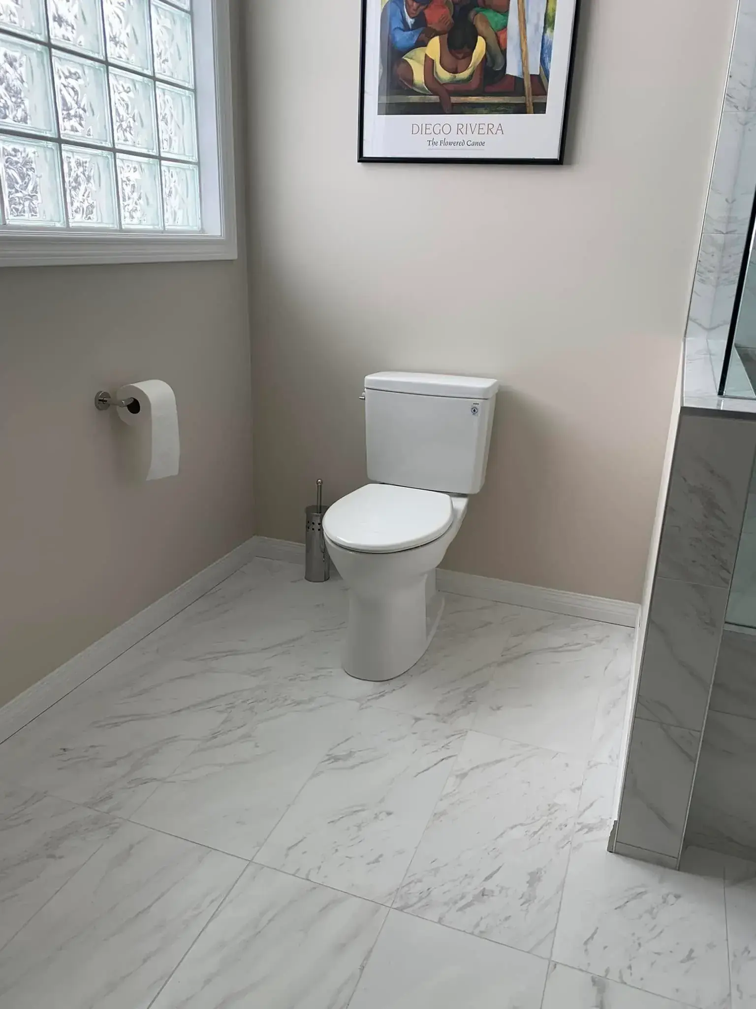 Renovated guest bathroom with modern fixtures, white cabinetry, and decorative tile