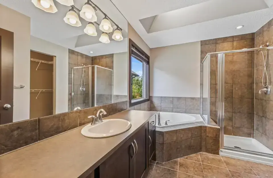 Contemporary powder room with floating vanity, designer mirror, and accent lighting