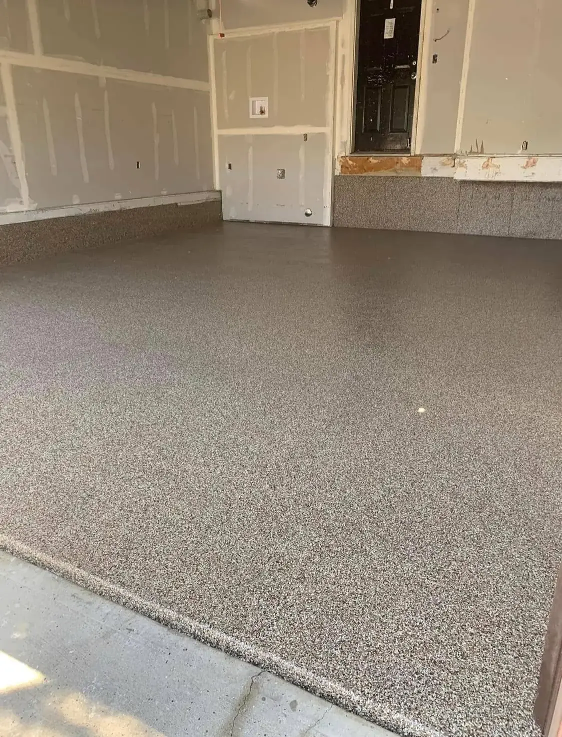Epoxy floor coating with decorative flake finish on residential garage floor in Calgary